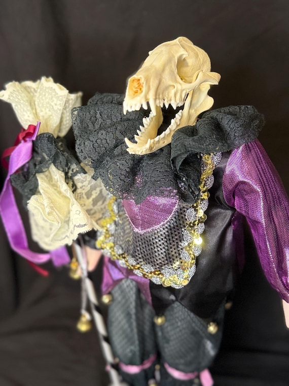 A genuine coyote skull fused into a vintage porcelain doll — unsettling, arresting, and unmistakably handmade oddity art.