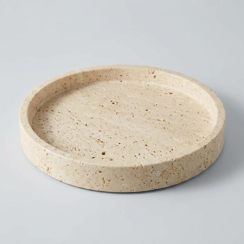 Angled view of travertine tray showing raised rim and honed natural stone finish