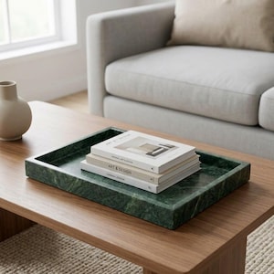 May include: A rectangular dark green marble tray with a smooth, polished finish and raised edges. Three stacked books with white covers rest inside the tray. The top book features the text Minimal Art & Design, the middle book Art & Design.