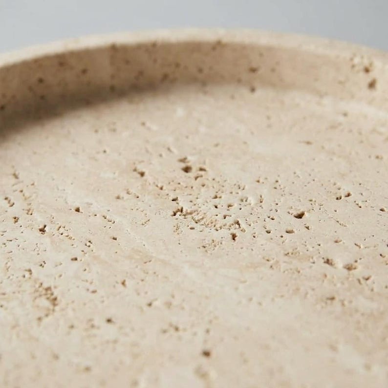 Macro close-up of travertine surface highlighting natural pitting and texture