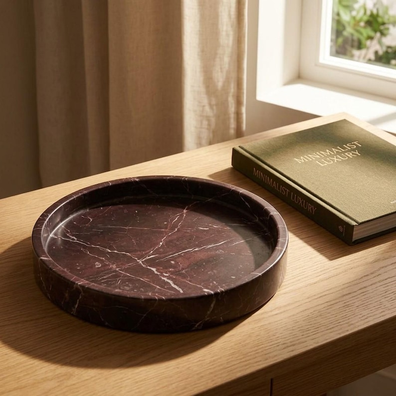 Rosso levanto marble catchall tray styled on wood console table beside a book