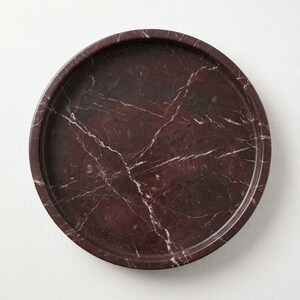 Overhead flat lay of round rosso levanto marble tray showing full veining pattern