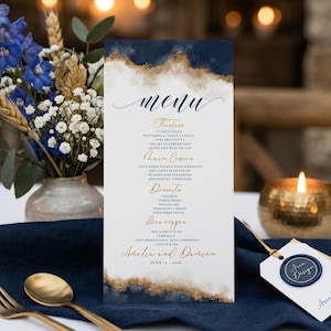 May include: A vertical wedding menu card featuring a white center with dark navy blue and gold foil-style watercolor edges. The text reads menu, Starters, Main Course, Desserts, Beverages, and the names Amelia and Darren with June 15, 2026.