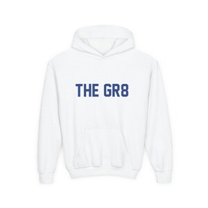 May include: White hooded sweatshirt with a navy blue print that says "THE GR8".
