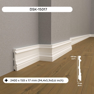 May include: White decorative skirting board installed at the junction of a wall and floor. The skirting board is 240 cm long, 15 cm wide, and 1.7 cm thick. The product code is DSK-15017. The skirting board is 15 cm high and 1.7 cm thick.