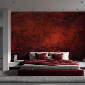 May include: A modern bedroom featuring a large bed with a burgundy headboard and bedding. The focal point is a textured, dark red accent wall. The room has large windows with sheer white curtains, a gray rug, and a matching burgundy ottoman.
