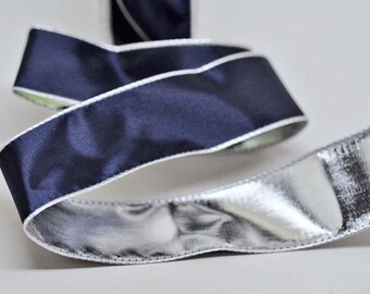 May include: A navy blue ribbon with a white edge and a silver metallic ribbon.
