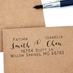 May include: Kraft paper envelopes with printed addresses. The addresses include the names Fatima Smith and Isabella Chen, along with a street address and city, state, and zip code. A blue pen and gold paper clips are in the background.