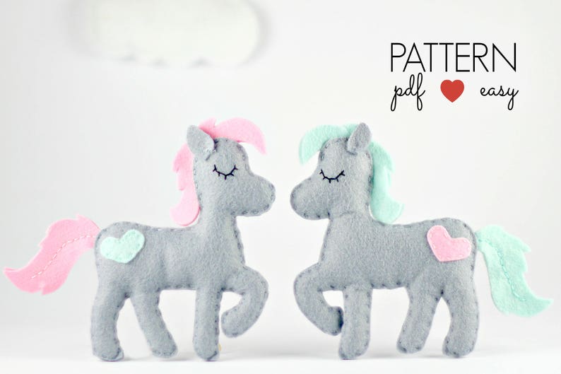 May include: A pattern for making two felt unicorn toys. The unicorns are gray with pink and blue accents. The pattern is available as a PDF download and is easy to follow. PATTERN pdf &hearts; easy