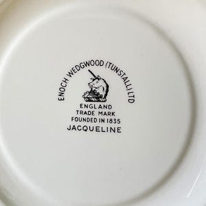 May include: A white ceramic plate with a black and white logo that reads "Enoch Wedgwood (Tunstall) Ltd. England Trade Mark Founded in 1835 Jacqueline"