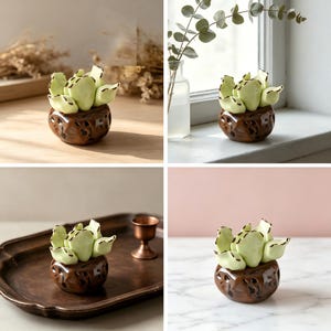 May include: A ceramic succulent figurine featuring pale green, rounded leaves with dark brown edges, set into a textured, dark brown, rounded pot with irregular indentations. The piece has a glossy finish and a compact, sculptural form.