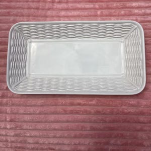 May include: White ceramic serving tray with a woven basket design. The tray is rectangular and has a smooth, glossy finish.