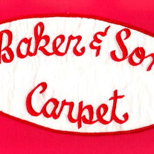 May include: White oval-shaped patch with red embroidered text that reads "Baker's Son Carpet".
