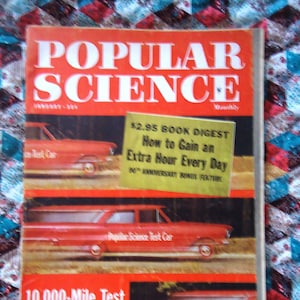 May include: A vintage "Popular Science" magazine cover. The title is in large white letters on a red background. The cover features images of red cars and text that reads "$2.95 BOOK DIGEST" and "10,000-Mile Test of New 4-Cylinder Chevy."