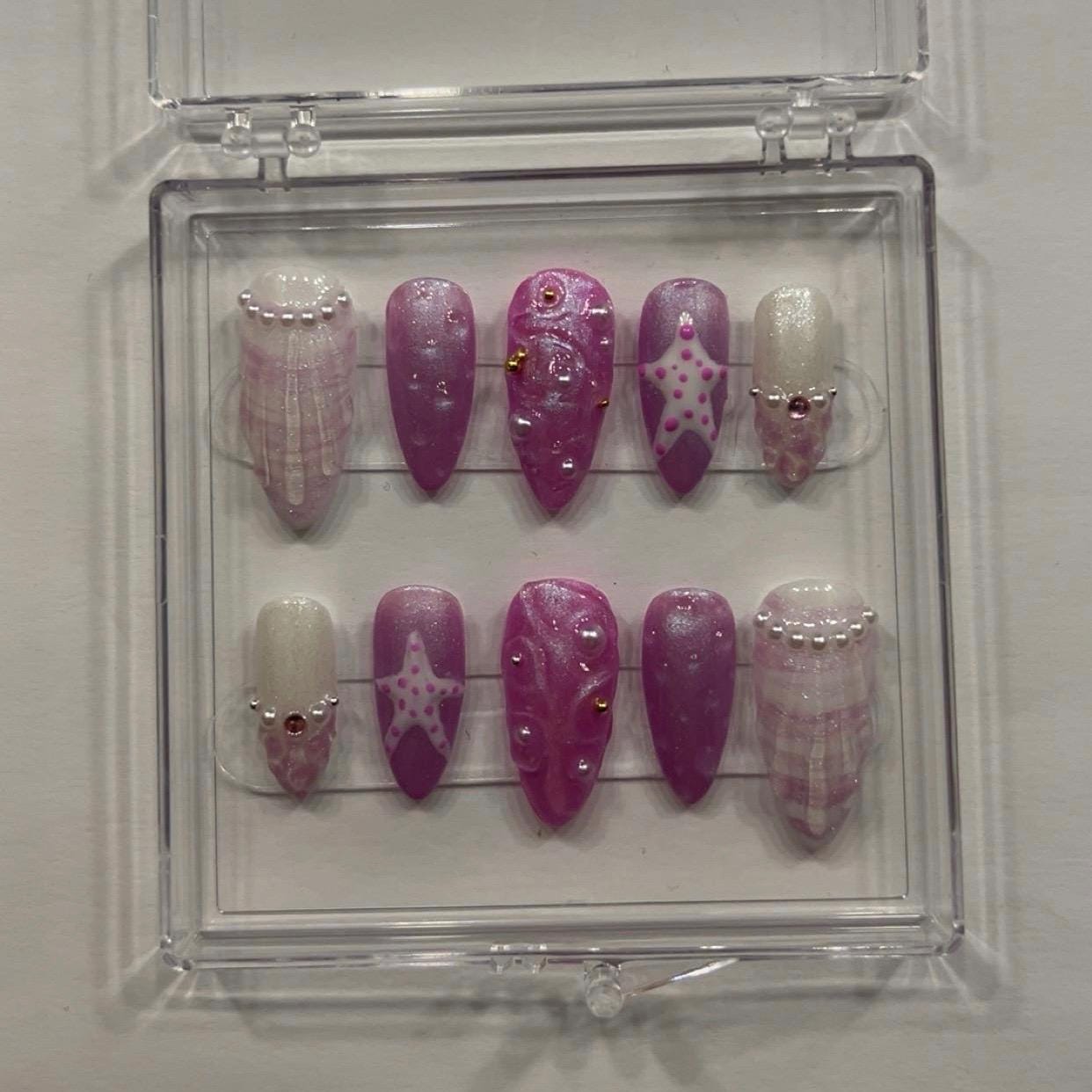 Purple beachy medium almond press on nails.