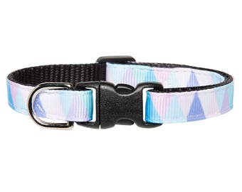 May include: A light blue, pink, and white cat collar with a black plastic buckle and a silver metal D-ring. The collar has a geometric pattern of triangles.