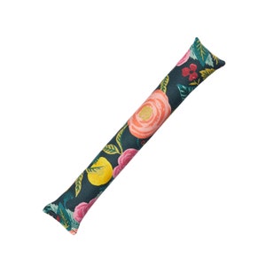 May include: A floral patterned doorstop in shades of pink, yellow, green, and red on a dark blue background.