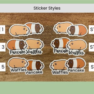 May include: A collection of six sticker styles featuring guinea pig illustrations. The stickers showcase guinea pigs in various poses and color combinations, with some including the text "Pancake" and "Waffles". The background is a wooden surface.