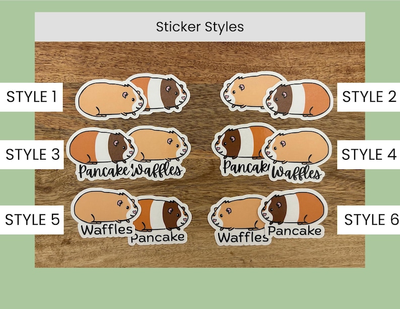 May include: A collection of six sticker styles featuring guinea pig illustrations. The stickers showcase guinea pigs in various poses and color combinations, with some including the text "Pancake" and "Waffles". The background is a wooden surface.