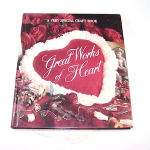 May include: A craft book titled "Great Works of Heart" with a red heart design on the cover. The cover features a heart-shaped design with white trim, surrounded by red roses and craft-related items.