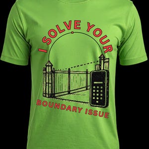May include: A lime green short-sleeve t-shirt featuring a graphic of a surveyor's transit and a fence. The text "I SOLVE YOUR" is arched above the graphic, and "BOUNDARY ISSUE" is printed in red below the illustration of the equipment.