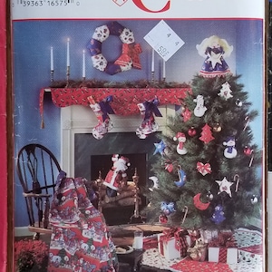 May include: Three vintage sewing pattern envelopes featuring Christmas-themed crafts. The patterns include designs for ornaments, stockings, and other holiday decorations. The envelopes are from Simplicity and Vogue Patterns.