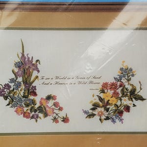 May include: A packaged embroidery kit featuring a framed floral design with the text "To See a World Picture." The kit includes cotton cloth, yarn, ribbon, a diagram, and a needle. The finished size is 16 x 12 inches.
