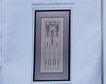 May include: Four counted thread cross stitch design kits featuring Frank Lloyd Wright architectural art glass window patterns. The packages are titled Early 20th Century Art Glass Window III, II, Wisteria Window, and May Basket, each with a graphic illustration.