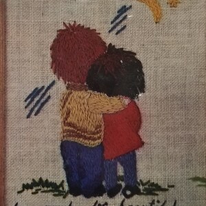 May include: A Creative Stitchery kit featuring a framed embroidery of two figures embracing, with the text "love makes life beautiful." The kit includes needlecraft homespun, crewel yarns, and an embroidery needle. The picture fits a 4.5 x 5.5 inch frame.