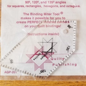 May include: Two clear plastic Binding Miter Tools in packaging. The tools have angles for squares, rectangles, hexagons, and octagons. Text on the packaging reads "Binding Miter Tool" and "AOP-201".