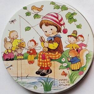 May include: Vintage round biscuit tin with a colorful illustration of a child fishing with fairies. The lid is orange and has text that reads "Huntley & Palmers Food Biscuits for children."