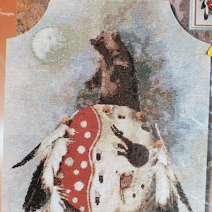 May include: A cross-stitch kit featuring an American Indian Bear Medicine Shield design. The kit includes Evenweave fabric, cotton floss, a needle, and instructions. Finished size is 14 x 20 inches (35.6 x 50.8 cm).