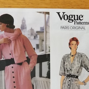 May include: Vogue Patterns Paris Original sewing pattern featuring a pink dress and jacket ensemble, and a gray dress. The pattern includes illustrations of the designs and the Yves Saint Laurent logo.