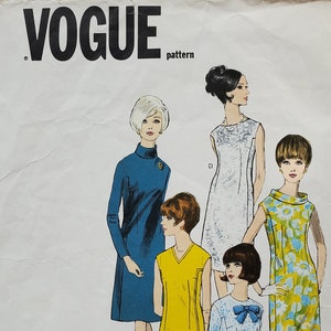 May include: Vintage Vogue pattern envelope featuring illustrations of five different dress designs. The envelope is off-white with the Vogue logo and text, "Easy to Make," and "Vogue's Basic Dress." The dresses are in various colors and styles.