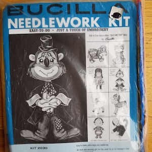 May include: A vintage Bucilla Needlework Kit for a "Buzzzie" the Clown toy doll. The kit includes all-cotton fabrics, felt, yarn, and instructions. The finished doll is 22 inches tall. The packaging is blue and features a black and white illustration of the clown.