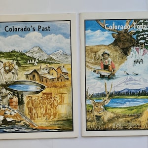 May include: Two vintage magazines titled "Colorado's Past" and "Colorado Today." The covers feature watercolor illustrations of Colorado landscapes, wildlife, and historical scenes, including mountains, a lake, and a person fishing.