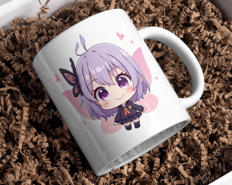 K&ouml;nnte beinhalten: Wei&szlig;e Keramiktasse mit einem niedlichen Anime-Charakter mit lila Haaren, gro&szlig;en lila Augen und einem schwarzen Outfit. Der Charakter hat einen Schmetterlingsfl&uuml;gel und ist von rosa Herzen umgeben. Die Tasse steht in einer braunen Box.
