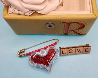Set of Two Heart Theme Lapel Pins, One Clear Heart with Red Glitter and One Pin that Spells LOVE with miniature Scrabble tiles,