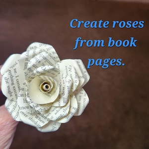 May include: A paper rose made from book pages, with text visible on the petals. The flower is white with a spiral centre and layered petals. The image includes the text "Create roses from book pages."