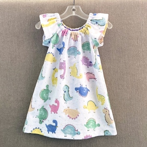 Nouveau ! Robe dinosaure fille avec manches flottantes, jolie robe à enfiler avec dinosaures pastel, robe paysanne confortable en flanelle de coton, tailles 12 m-8