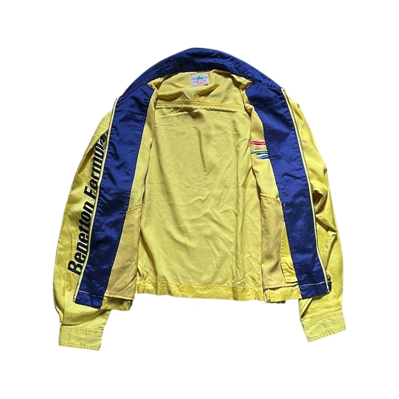May include: A yellow and blue vintage jacket with the text "Benetton Formula" on the left sleeve.