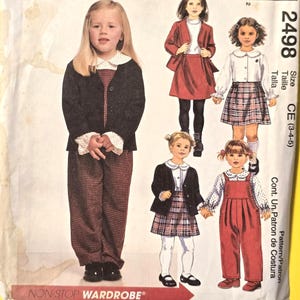 May include: McCall's sewing pattern featuring children's clothing designs. The pattern cover displays illustrations of various outfits, including a blazer, skirt, and overalls. The text "NON-STOP WARDROBE" is visible.