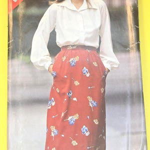 May include: A vintage sewing pattern titled "See & Sew 3263" featuring a woman wearing a white blouse and a red floral skirt. The pattern size is B (14-16-18). The image is on a yellow background.