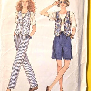 May include: Simplicity sewing pattern 8878 for a vest, short-sleeved top, pants, and shorts. The envelope features illustrations of two outfits: one with a floral vest and striped pants, the other with a floral vest and solid blue shorts.