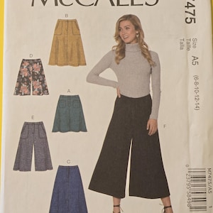 May include: McCall's M7475 sewing pattern featuring various skirt and pants designs. The pattern includes size A5 (6-8-10-12-14). The image shows a woman wearing wide-leg pants. The pattern is from Angel Patterns.