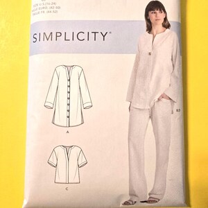 May include: A Simplicity sewing pattern packet with the text "EASY-TO-SEW" and "SIMPLICITY". The pattern includes illustrations of a long-sleeve shirt and pants, and a short-sleeve shirt. The packet shows a woman wearing the outfit.