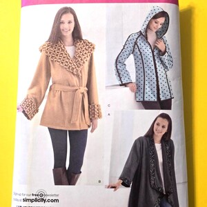 May include: Simplicity sewing pattern 2208 for jackets in sizes XS, S, M, L, XL. The package displays three jacket variations: a tan belted jacket with textured cuffs and collar, a light blue hooded jacket with dark polka dots, and a dark gray open jacket.