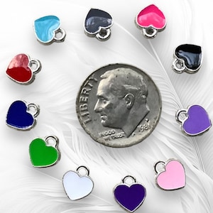 May include: Assortment of 12 small heart-shaped charms with different colored enamel finishes. The charms are silver-toned and have a loop for attaching to jewelry or other crafts.