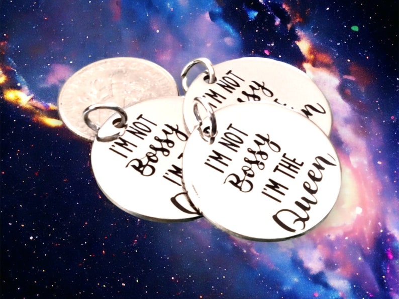 May include: Four silver charm pendants with the text "I'm not bossy, I'm the queen" on one of the pendants.