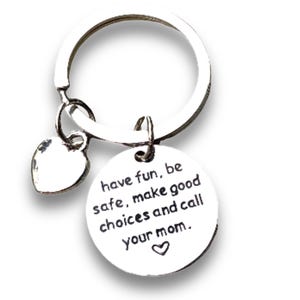 May include: Silver keychain with a heart charm and a round charm that says "have fun, be safe, make good choices and call your mom."